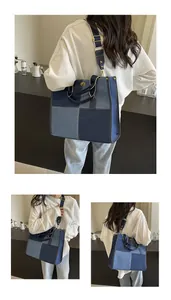 Detailed view of the patchwork denim tote bag with golden hardware and wide strap