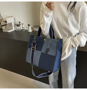 Patchwork denim tote bag shown with shoulder strap in a stylish lifestyle setting