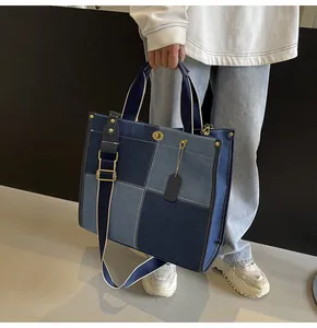 Detail of patchwork denim tote bag with metal twist lock and adjustable wide strap