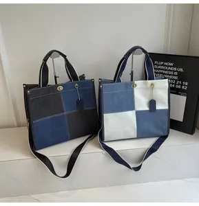 Detail view of patchwork denim tote bag with metal twist lock and adjustable wide strap