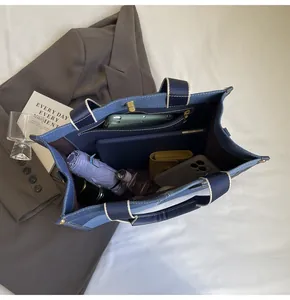 Top view of large patchwork denim tote bag showing spacious interior with daily essentials