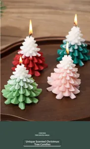 Macro detail of layered Christmas tree scented candles in gift box setting