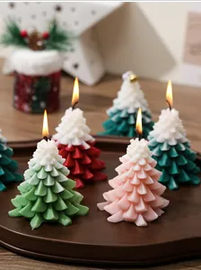 Detailed view of lit Christmas tree candles in gradient colors on a wooden tray