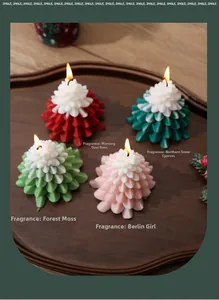 Christmas tree candles in four scents on a wooden tray with festive pine decor