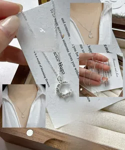 Macro detail of S925 silver crescent moon necklace with zircon stones and fine chain
