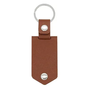Brown lychee leather keychain with silver metal ring and rivets on white background