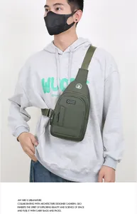 Detail of army green oxford sling bag featuring multi-pocket design and adjustable strap