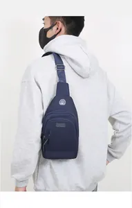 Outdoor navy blue crossbody bag with multiple zippers and earphone port on sport model