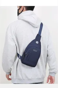 Back view of a navy blue oxford fabric crossbody chest bag worn for outdoor activities