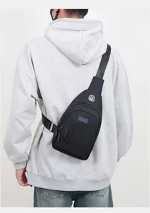 Detail view of a black oxford chest bag for men showing waterproof fabric and earphone port