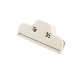 Detail view of cream-colored plastic food sealing clip with spring mechanism