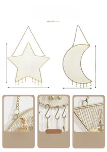 Detail showing gold metal mesh wall jewelry organizer with moon and star shapes