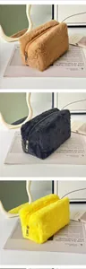 Plush makeup bags in brown, black, and yellow colors with soft faux fur and metal zippers
