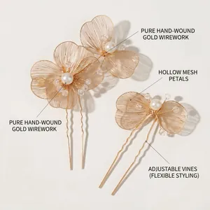 Detailed macro view of handmade gold wire hairpins with hollow mesh petals and pearls