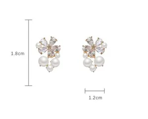 Detailed view of flower stud earrings with crystals and pearls measuring 1.8cm by 1.2cm