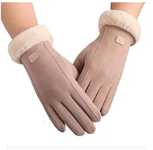 Detail of warm winter gloves with faux fur trim and fashion leather patch on wrist
