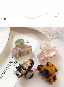 Set of four premium acetate hair claws featuring vintage floral and marble textures