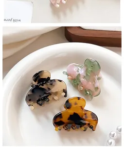 Close-up of elegant acetate hair claws with marble and tortoiseshell patterns