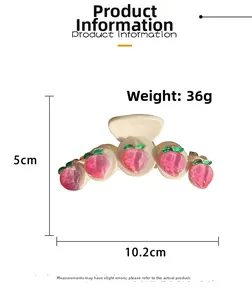 Detail view of large peach hair claw clip with 10.2cm length and 5cm height dimensions