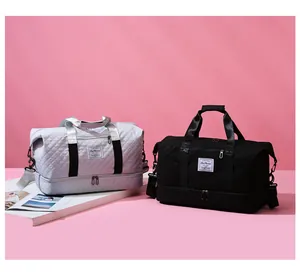 Detail of quilted sports travel bags in grey and black featuring a separate shoe compartment