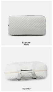 Detailed top and bottom views of a white quilted travel bag with premium stitching details