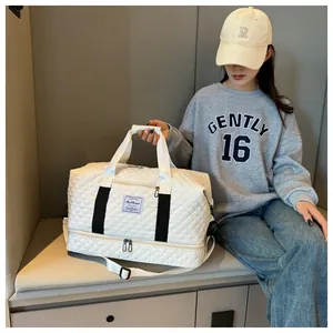 Detail of white quilted travel bag with large capacity and separate bottom compartment