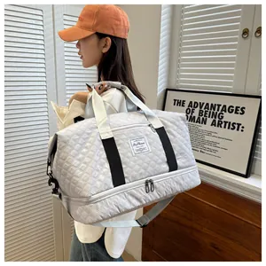 Detail view of the quilted white travel bag with double layers and adjustable strap