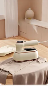 Detail view of a portable garment steamer with digital display on a beige shirt