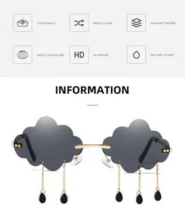 Close-up of cloud-shaped rimless sunglasses with dangling gold chains and black teardrop tassels