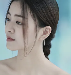 Elegant S925 silver long linear drop earrings shown on a female model's side profile
