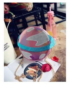 Close-up of holographic planet-shaped bag with silver glitter patches and golden chain strap