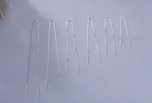 Close-up showing six lengths of S925 sterling silver box chain drop earrings on grey background