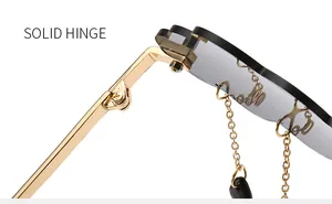 Close-up of durable golden metal hinges and gray lenses with decorative chains