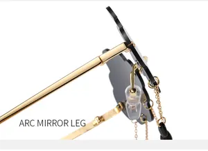 Detail of gold metal arc temple arm with black teardrop chain charm on cloud sunglasses