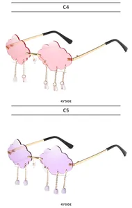 Detail view of cloud-shaped rimless sunglasses with pink and purple gradient lenses and charms