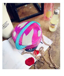 Close-up of laser finish glitter planet crossbody bag with golden chain strap
