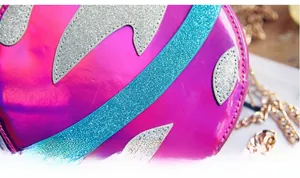 Detailed close-up of rose red holographic round crossbody bag with glitter pattern