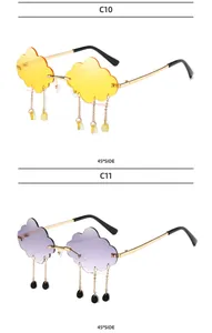 Detail view of cloud-shaped rimless sunglasses in yellow and purple with teardrop charms
