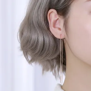 Minimalist S925 sterling silver long chain threader earrings worn by a model