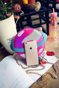 Detail of creative planet-shaped laser bag with gold chain and size reference
