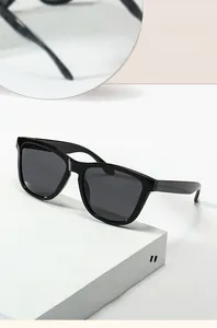 Close-up of modern black polarized sunglasses featuring a thick frame and grey lenses