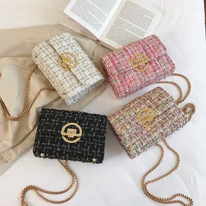 Top view of four tweed chain bags in white pink and black with golden metal hardware