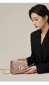 Macro detail of rainbow tweed chain bag with elegant gold round twist lock hardware