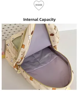 Spacious interior of a beige school backpack featuring light purple lining and mesh pockets