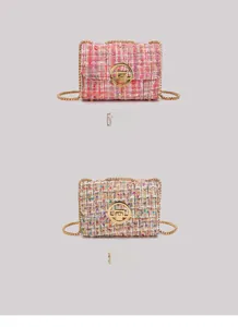 Detail of tweed crossbody bags with golden circular clasps and chain straps
