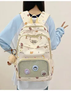 Detailed view of canvas backpack with cute brown bear prints and decorative plush charms