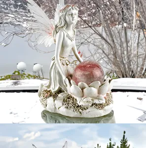 Detail of flower fairy garden ornament with pink solar cracked glass ball and lotus base