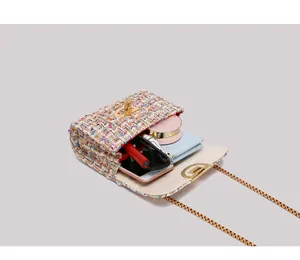 Interior view of colorful tweed crossbody bag showing phone, sunglasses and lipstick storage