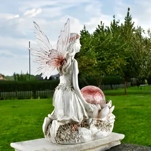 Solar powered garden flower fairy figurine with glowing pink orb and purple wings
