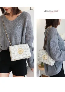 Detailed view of white tweed shoulder bag with gold chain and round metallic clasp